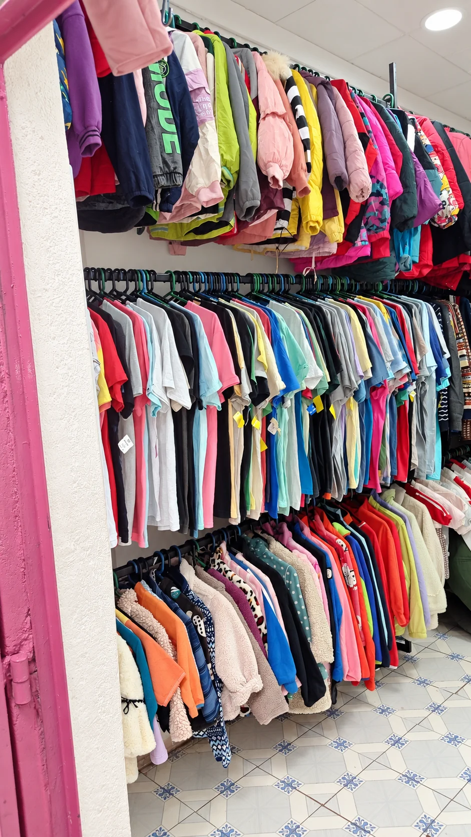 Rows of jackets and tops on the clothing rails inside Newbies Family Fashion